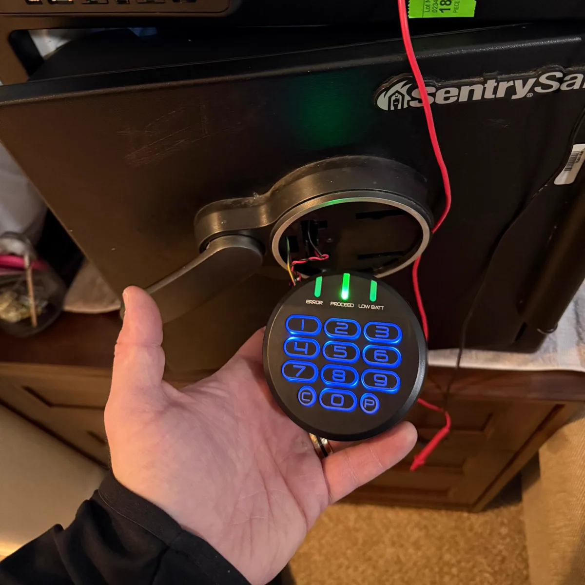 Electronic safe lock and keypad removed from a safe door for diagnosis