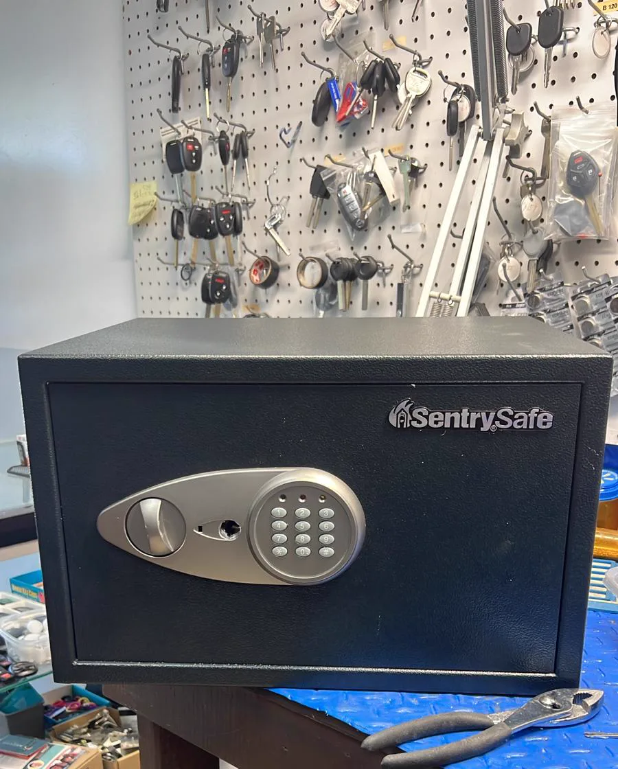 Small safe disassembled on the workbench in the locksmith shop