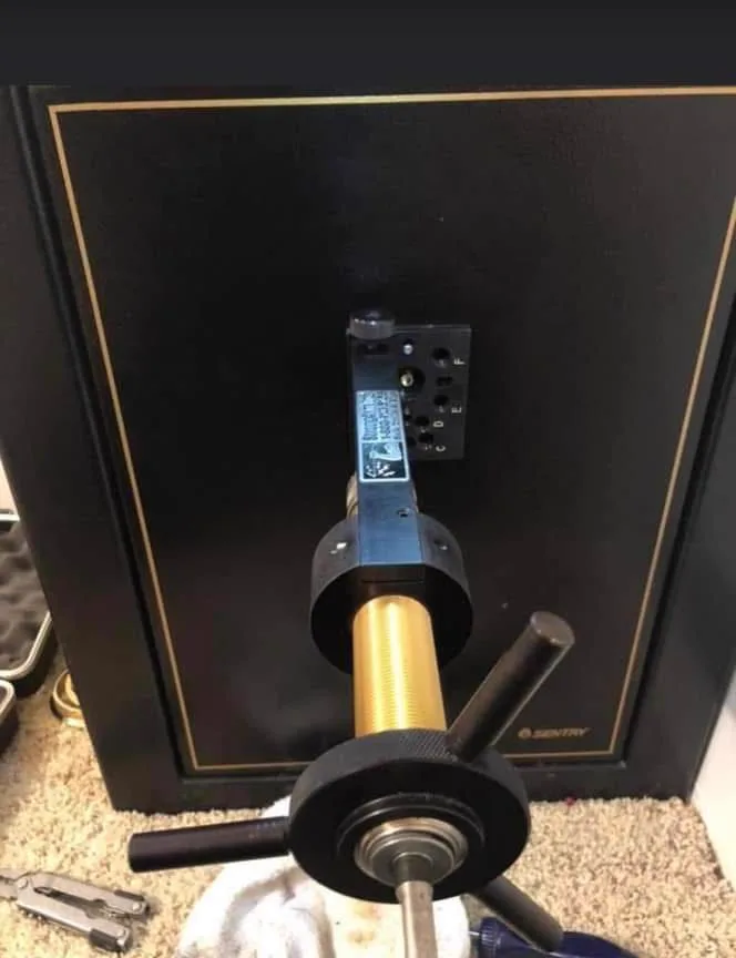 Drill rig mounted on the door of a Sentry safe during an opening